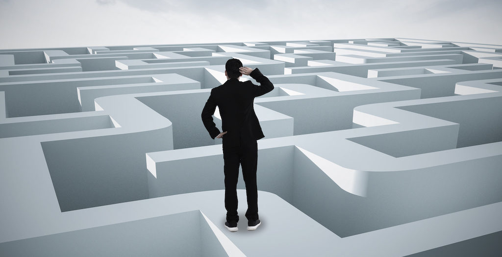 Businessman going straight ahead on a wide road between mazes guidance365 guidance